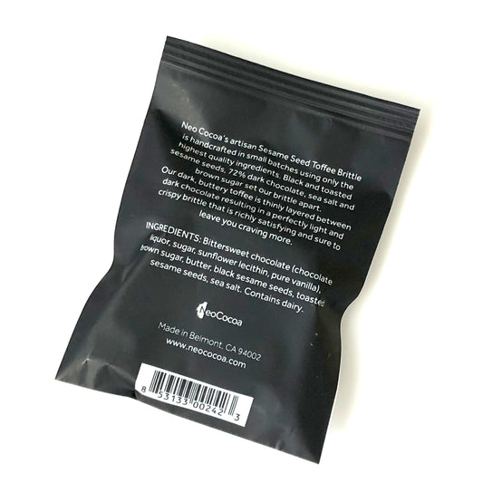 Back side of Sesame brittle 1oz sized bag with description of product, ingredients, bar code and logo.