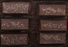 Load image into Gallery viewer, View from above of the opened “Almond Butter Smoked Sea Salt” with six chocolate truffles arranged in two rows, 3 truffles per row, each in paper candy cup.