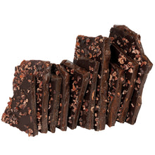 Load image into Gallery viewer, Close up of several pieces of nib brittle candy vertically stacked.