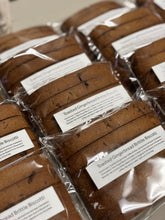 Load image into Gallery viewer, Packaged toasted gingerbread brittle biscotti with labels on a neutral background