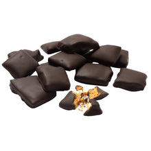 Load image into Gallery viewer, A pile of chocolate covered honeycomb candy pieces with one piece broken open to expose honeycomb candy inside.