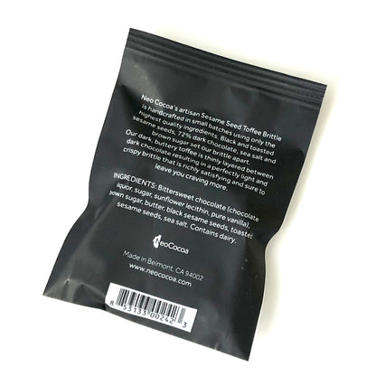 Back side of Sesame brittle 1oz sized bag with description of product, ingredients, bar code and logo.
