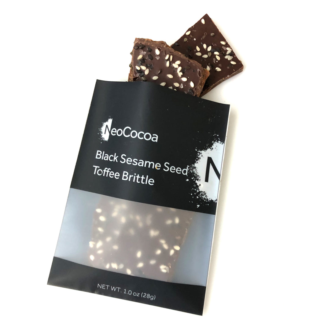 Sesame brittle pouring out of 1oz sized bag with label stating “Black Sesame Seed Toffee Brittle” and NeoCocoa logo.