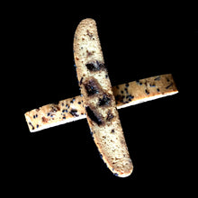 Load image into Gallery viewer, 2 pieces of sesame brittle biscotti criss-cross each other. The toffee bits can be seen inside the biscotti.