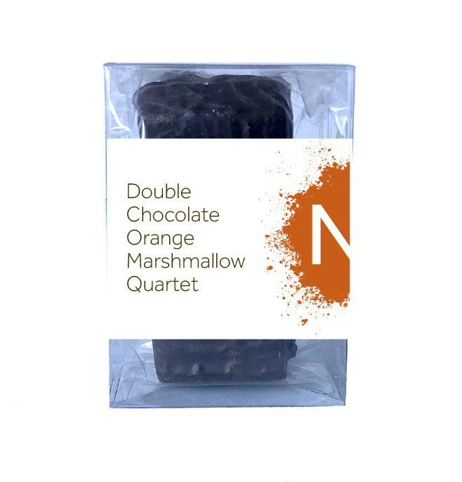 Front side of dark chocolate covered chocolate marshmallows in the clear bag in a clear box, wrapped with a label stating “Double Chocolate Orange Marshmallow Quartet” and NeoCocoa logo.