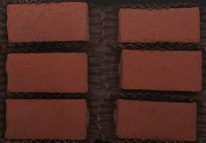 View from above of the opened “Mocha Cinnamon” with six rectangle-shaped chocolate truffles arranged in two rows, 3 truffles per row, each in paper candy cup.