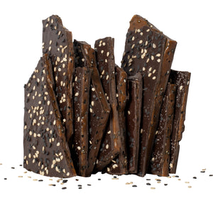 Close up of several pieces of sesame brittle candy stacked.