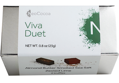 2 dimensional rectangle silver box with a label wrapped around the box stating, “Viva Duet” with NeoCocoa logo and net weight  0.8 oz (23g). Can see a little of the side of the label with image of one almond butter smoked sea salt truffle and one zester lime truffle.  